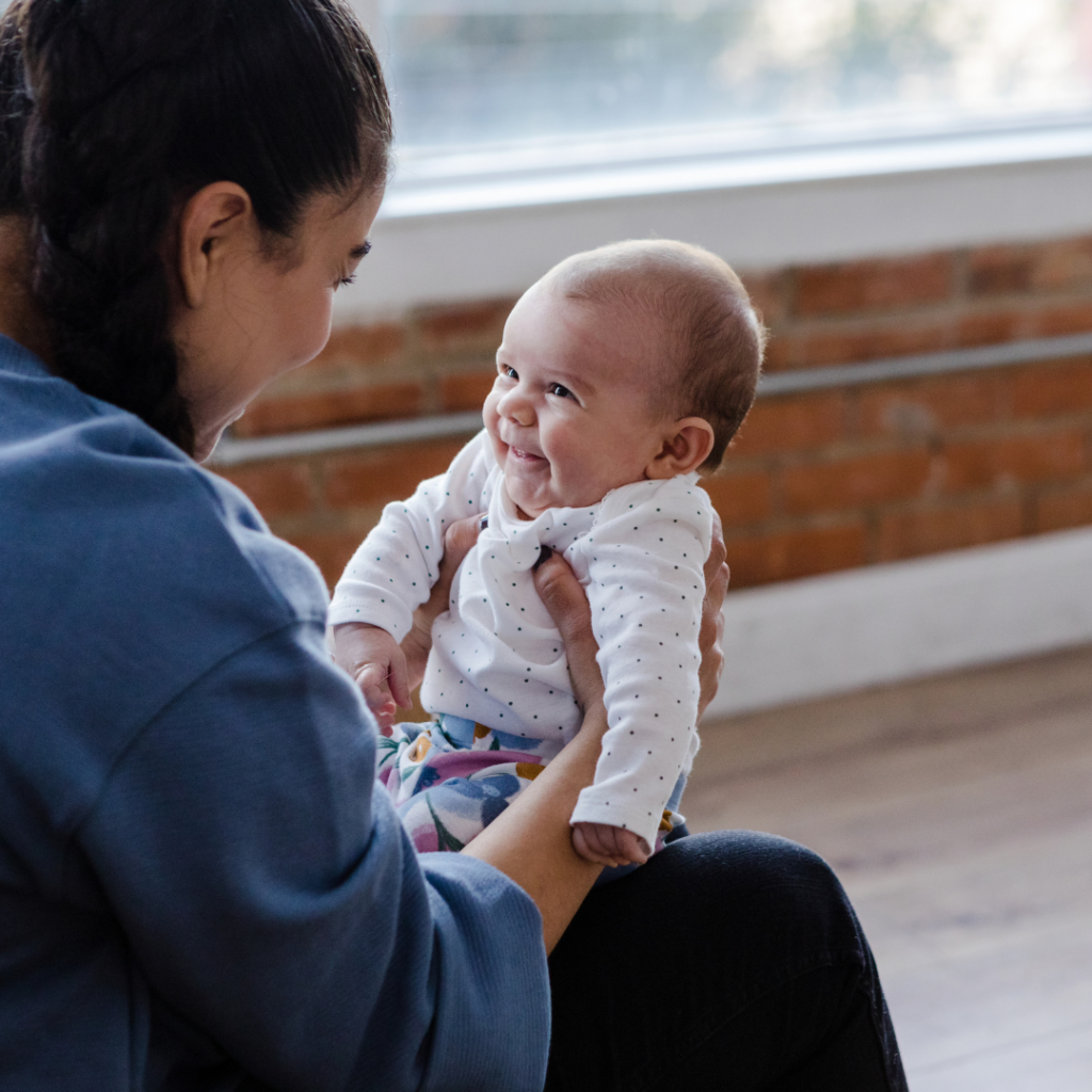 smiling baby in response to carer