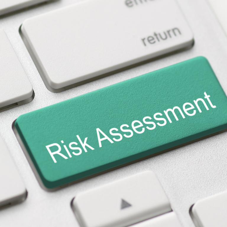 A keyboard with a large green Risk Assessment key.