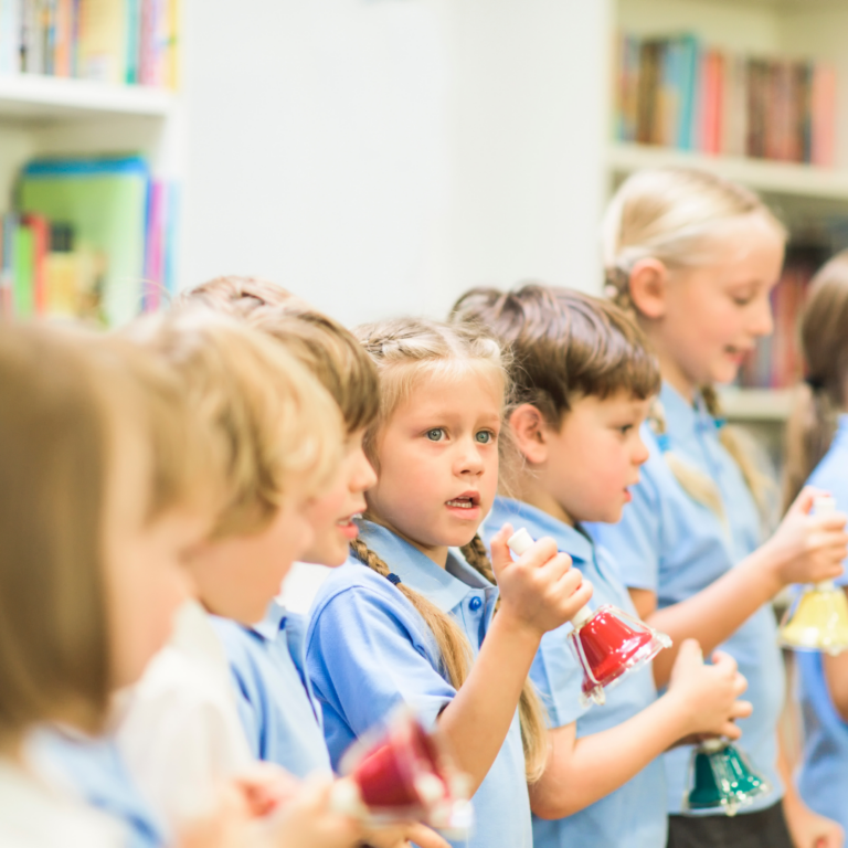 children at primary school in a music lesson with hand bells