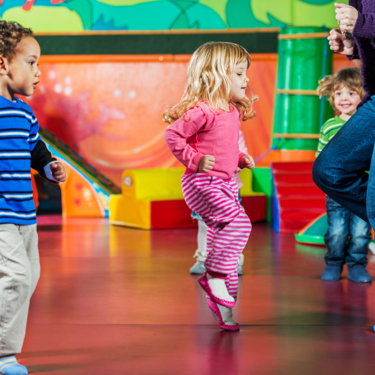 Preschool children dancing and jumping as if in time to music