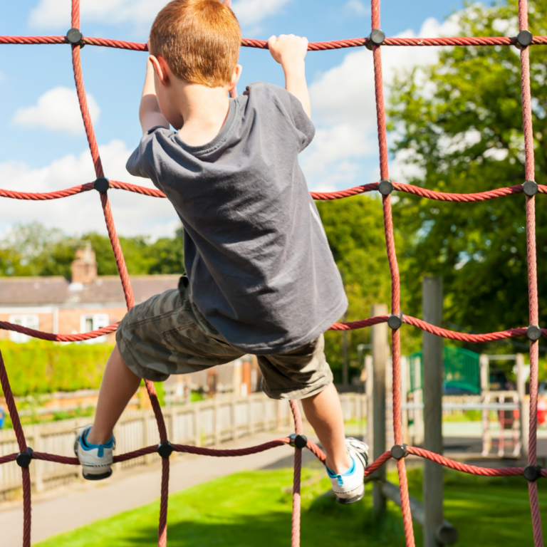 Child climbing a rope climbing frame