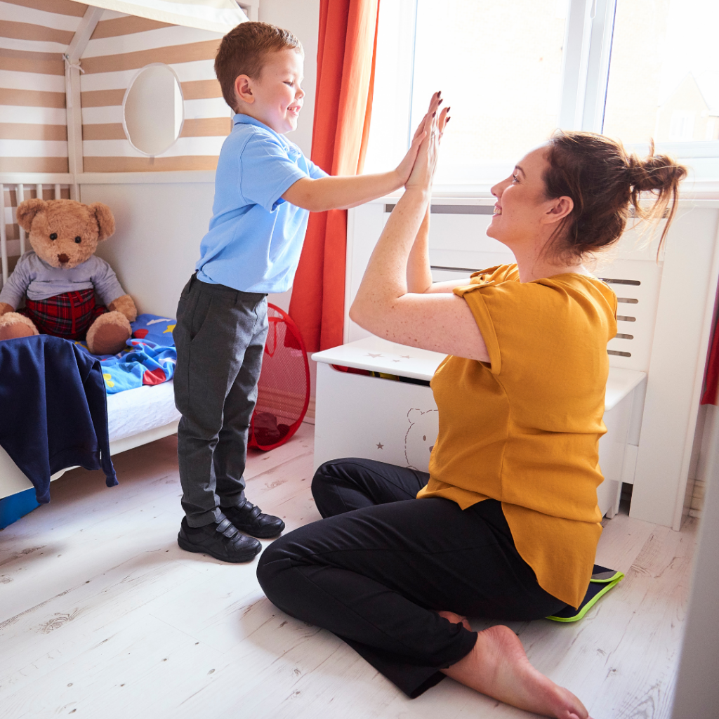 An image of a child and parent high fiving success