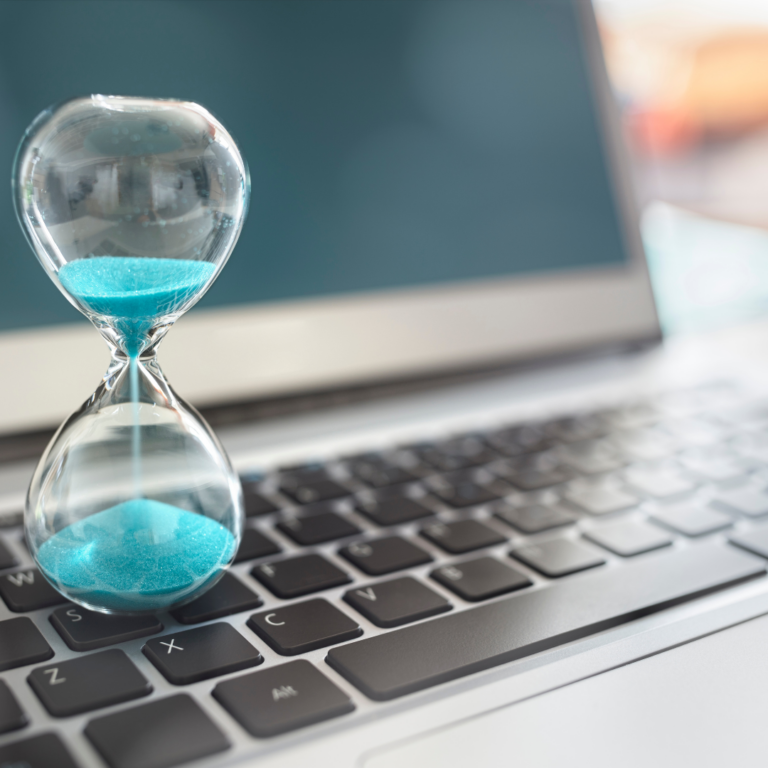 An image of a sandtimer on top of an open laptop to represent time management and resilience