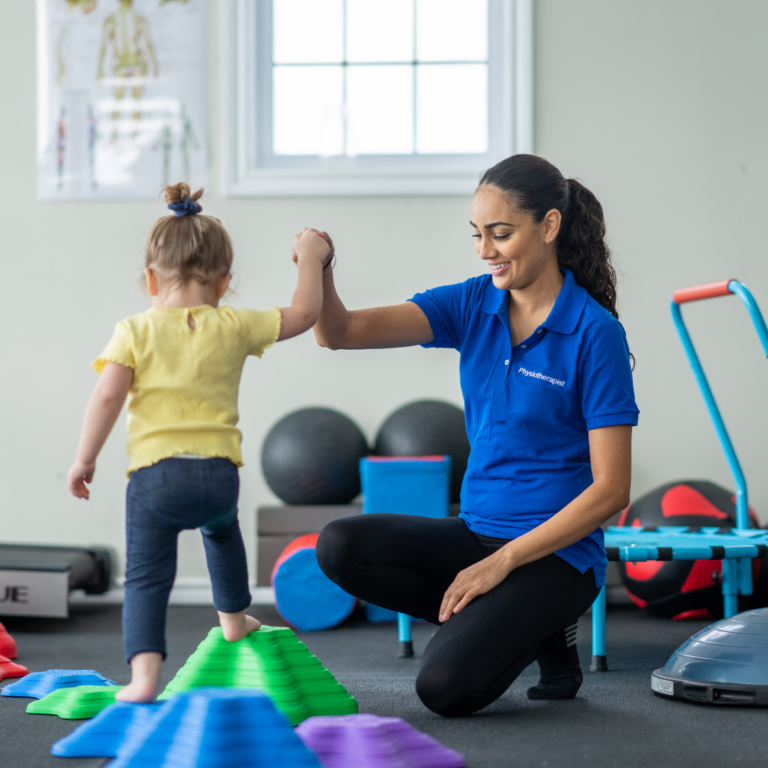 An adult supporting a child on a climbing frame