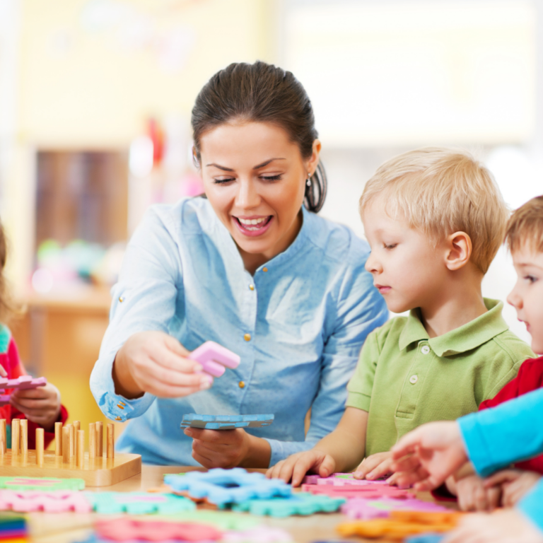 Nursery practitioner supporting a child with SEND at a table top activity.